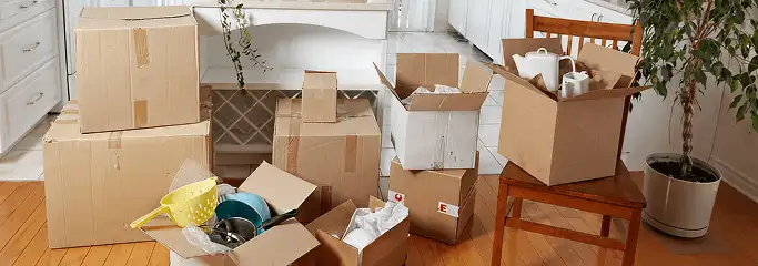 Packed moving boxes and household items in a kitchen before move-out or move-in cleaning, Chicago, IL.